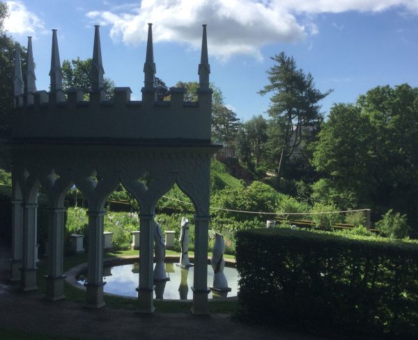 Scenes of woodland and ceramic sculpture through the Exedra.