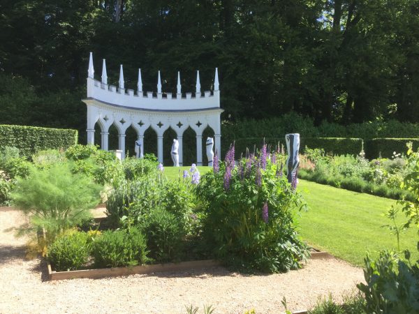 Sculpture among the flowers in an interesting and beautiful garden
